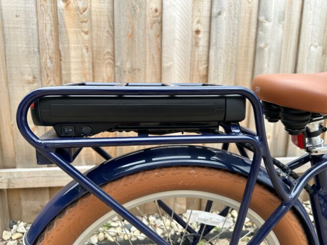 The battery pack sits inside the rack, which limits the kind of bike bags you can attach to it. Note the power switch at the bottom left. You'll need to toggle this switch before turning the bike on.