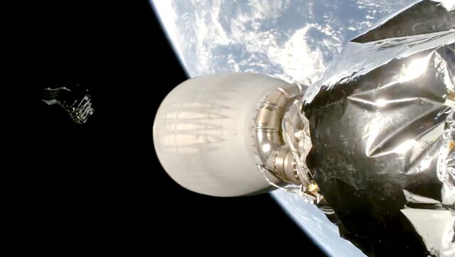 This frame from a SpaceX video shows 22 Starlink satellites (upper left) soon after deployment from a Falcon 9 rocket, seen in the foreground.