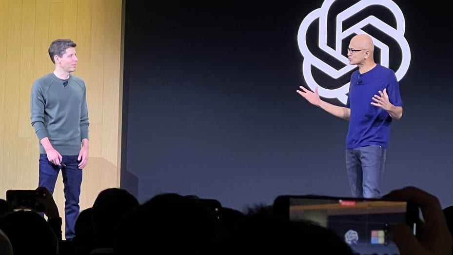 Microsoft CEO Satya Nadella, right, speaks with OpenAI CEO Sam Altman at OpenAI's Dev Day in San Francisco on Nov. 6, 2023.